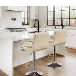 Two cream leather bar stools