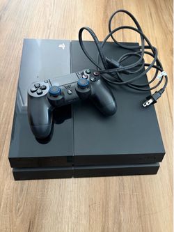 PS4 PlayStation4 console with a controller and power cord