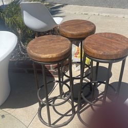 Three metal and wood high barstools