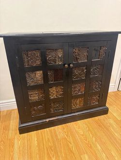 Vintage Black Cabinet with Carved Doors – $40