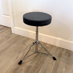 Round, black, padded drum throne with chrome-plated, double-braced legs (height adjustable)