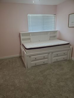 Twin bed frame with bookcase.
