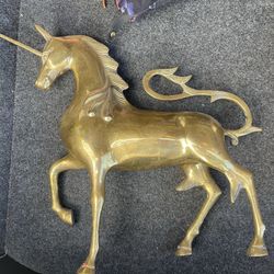 vintage solid brass unicorn sculpture, popular in mid-century and Hollywood Regency interior design styles.  Material: Solid brass with a polished gol