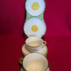 Pair Of vintage Mottahedeh Italian Majolica pottery tea set featuring a daisy-shaped cup and combined plate and  saucer. 