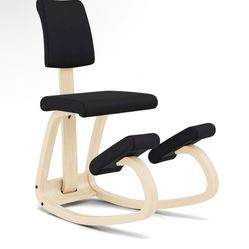 This is a Sleekform East Austin Kneeling Chair with black cushions and a natural wood frame. 