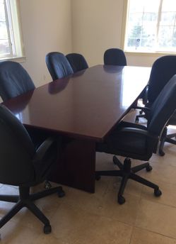 Beautiful mahogany conference table with a glossy finish and include 8 chairs