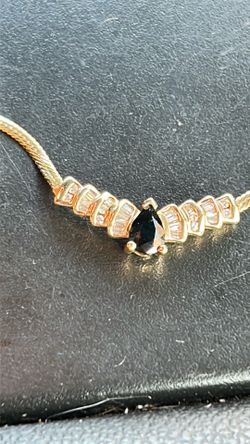 14k gold pear shaped sapphire with round and baguette diamonds