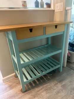 Indoor/outdoor console table with two wheels