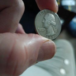 1983 Capital D Quarter Dollar With In In God We Trust Blurred And Blended Together.