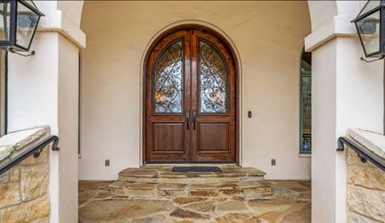 Double Arched Solid Wood Paneled Doors With Glass And Iron Design