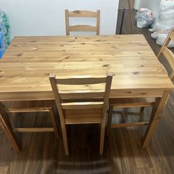 wood table with four chairs 