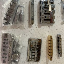 Bunch of guitar parts (Gibson,Badass,Fender). Not sure how complete they are as somebody needs some screws or something to mount them.  Three sets of 