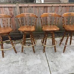 Vintage colonial swivel chairs with brass plated foot rest set of 4