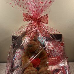 Valentine’s Day gift basket. Stuffed Lion, Hot Chocolate, Heart Travel Mug, Valentine’s Gummies, Chocolate Truffles. 