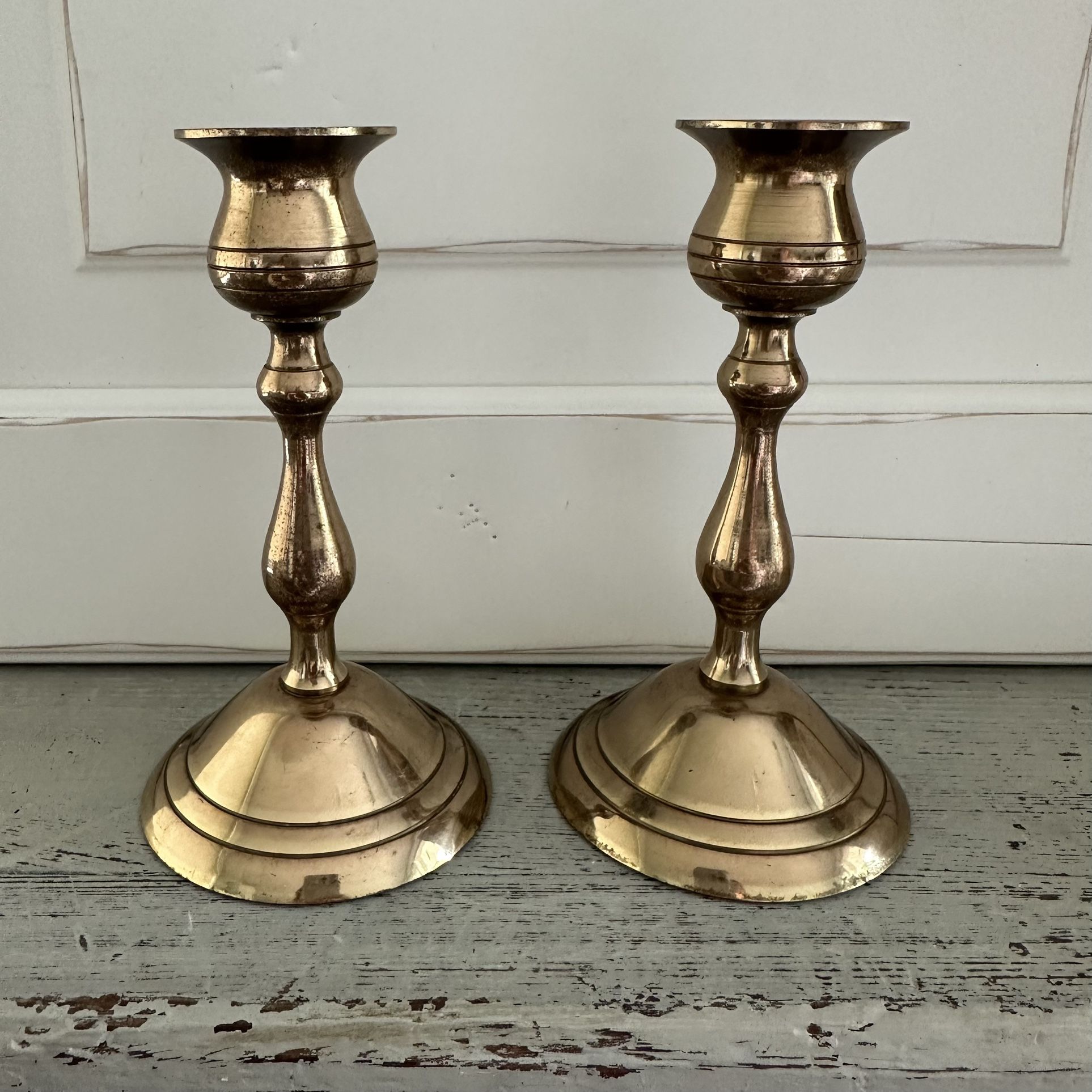 Set of two vintage brass candle stick holders. 5 1/2” tall x 3” across the base.