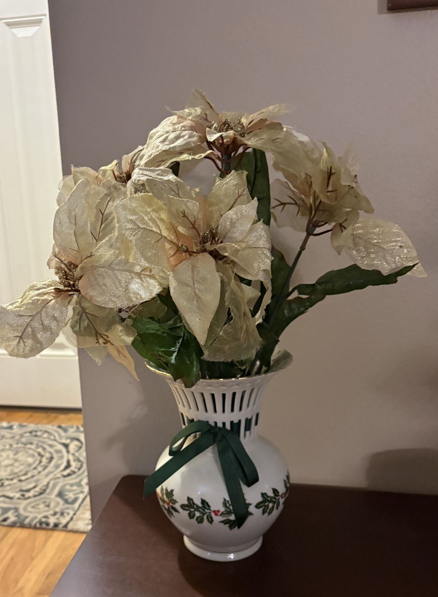 Holly Collection porcelain vase with a reticulated top, holly berry design, and a green ribbon