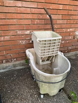 Grocery basket on wells and Rubbermaid mop bucket