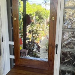 Vintage oak hall tree mirror, brass hooks, and a lower storage drawer