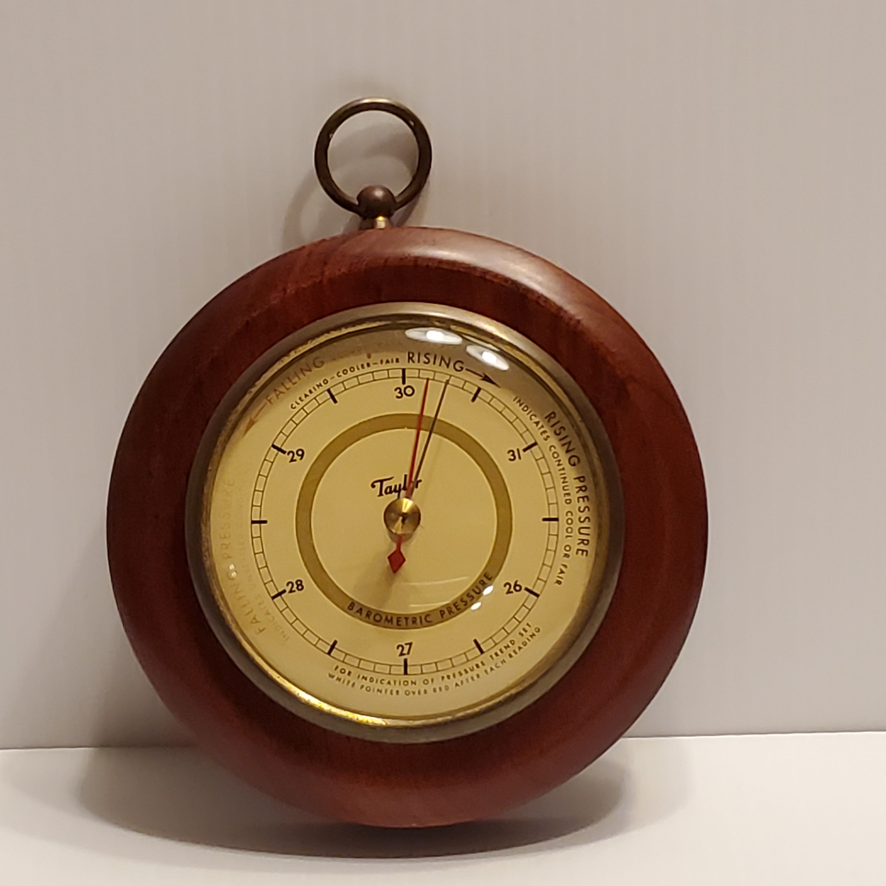 Vintage Taylor barometer with wood frame. 5 ¼” diameter.