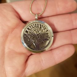Locket With A Cut Out Tree On Front