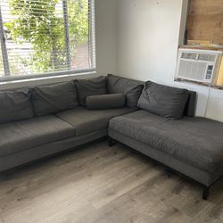Grey Sectional L-Couch With Right Bumper (Dogs Not Included)