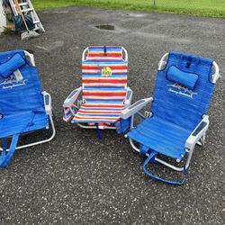 Three Tommy Bahama beach chairs was coolers on the back and straps for caring two events