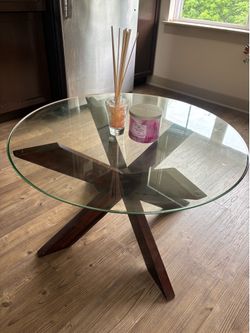 Round Glass Top Coffee Table with Dark Wood Starburst Base