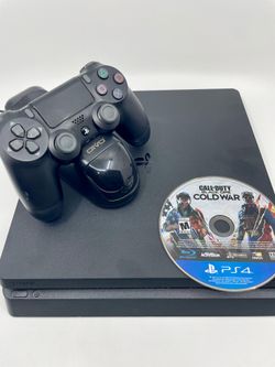 PS4 slim with controller, cables, and game