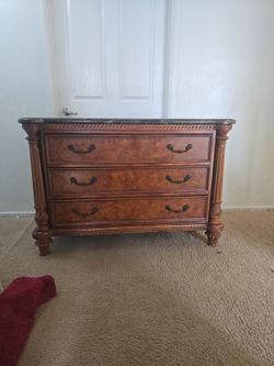wood dresser featuring with a dark marble top