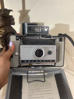 Untested collectible vintage Polaroid Automatic 230 Land Camera from the 1960s, featuring a gray body and black bellows.