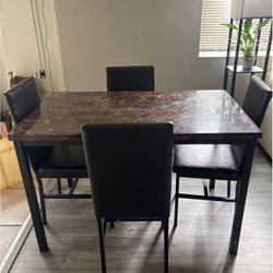 Brown Marble Table With Brown Leather Chairs  
