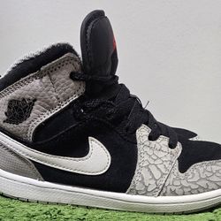 Nike Air Jordan 1 Mid SE 'Elephant Toe' sneakers, featuring a black suede base with signature gray elephant print detailing on the toe and heel. 
Grea
