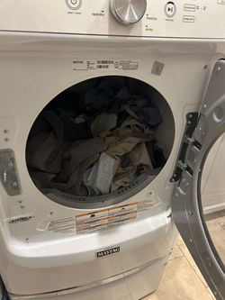 Maytag washer and dryer pair with storage stands