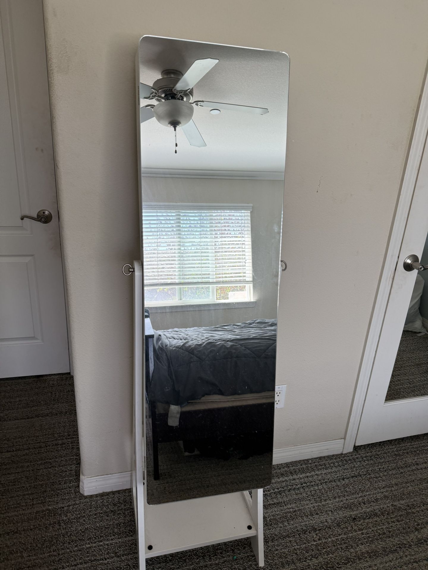 white standing mirror with jewelry cabinet