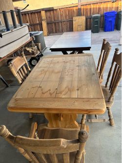 Two tables one has 4 chairs