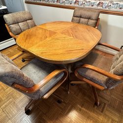 Solid Wood Kitchen Table With Four Rolling Chairs