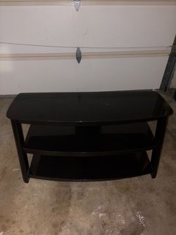 TV stand glass black 50in wide 20 in tall 2 rolls