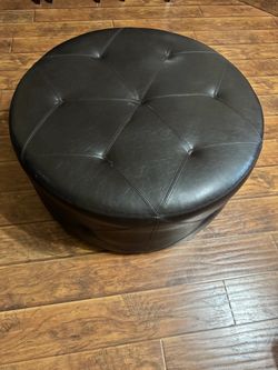 Brown faux leather round tufted cocktail ottoman with buttons from Rooms to Go. Originally 299.00