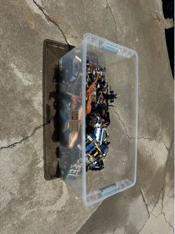 Bin of Legos and assorted dinosaur toys