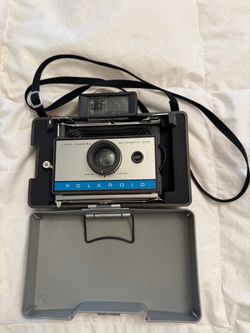 Vintage Polaroid folding bellows instant camera in gray with metal support arms and accordion-style bellows TESTED WORKS