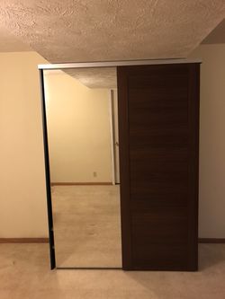 Brown wooden closet with mirror