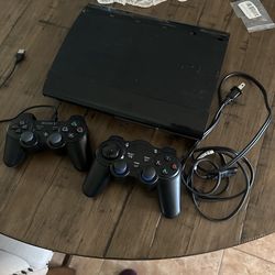 PS3 with 2 remotes 1 game