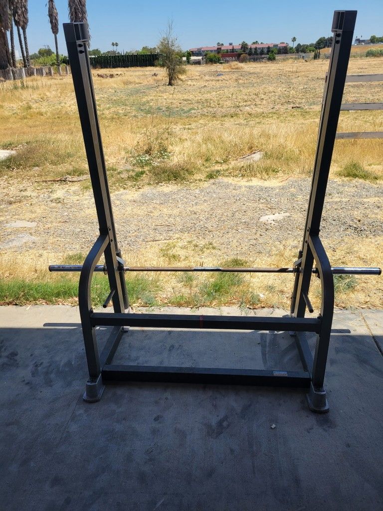 Commercial-grade Cybex C800 half rack, solid steel frame, includes Olympic bar; selling as-is, no plates or bench