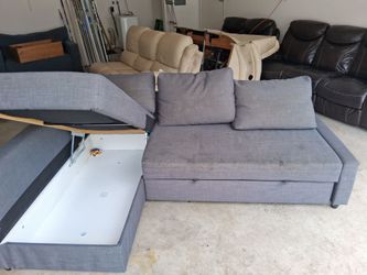Full size Corner couch with build in storage.  Pulls cushion to make full size bed