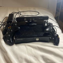 black Microsoft Xbox 360 S console, commonly referred to as the Xbox 360 Slim. With Xbox 360 Kinect