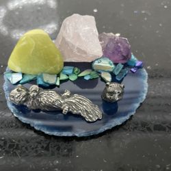 Polished Raw Crystal Arranged on a Circular Coaster and Small  Metallic Figures 