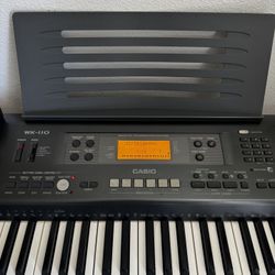 Casio WK110 Portable Keyboard Piano with Sony headphones