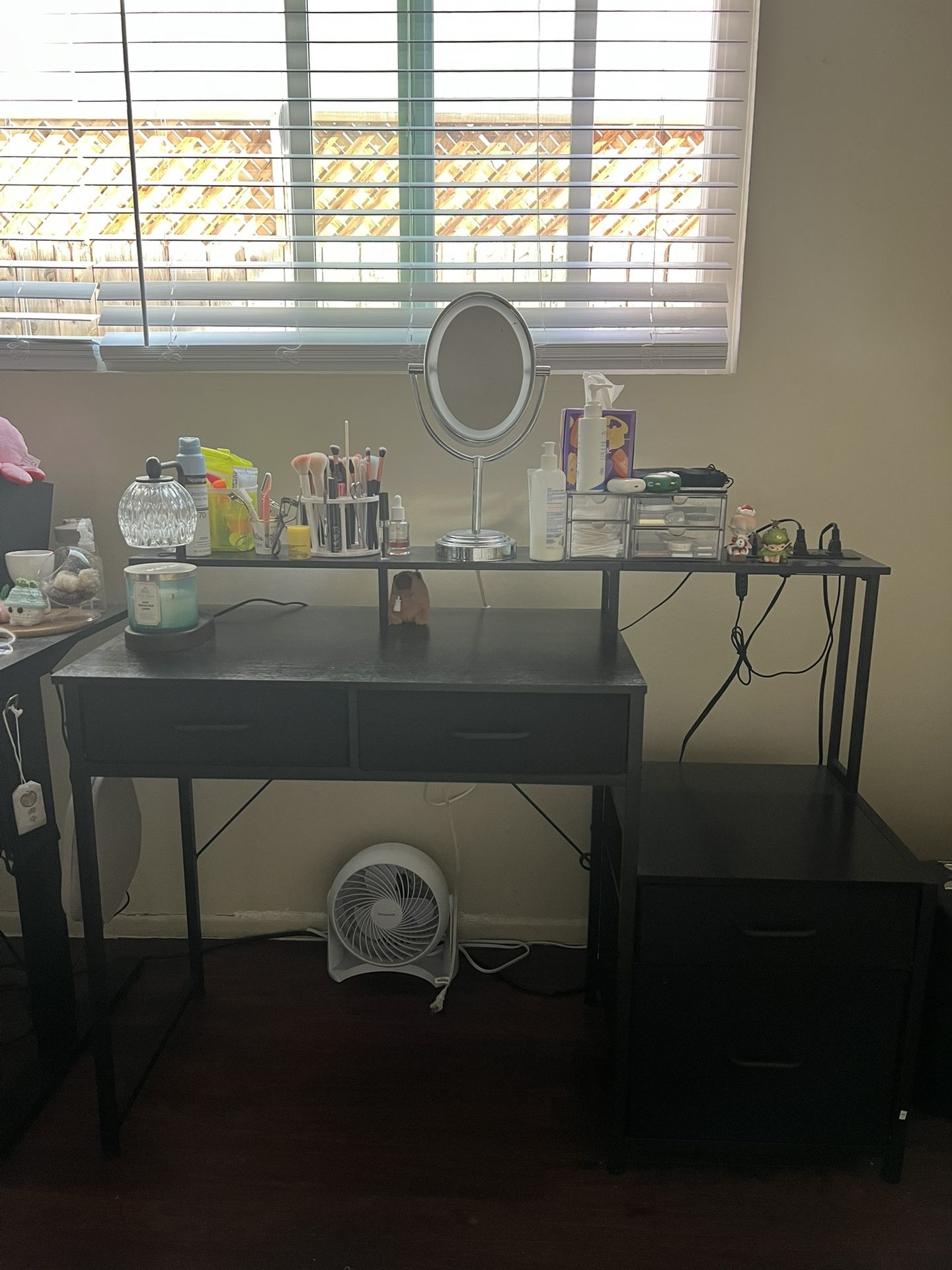 black computer desk with drawers, led lights, and power outlet
