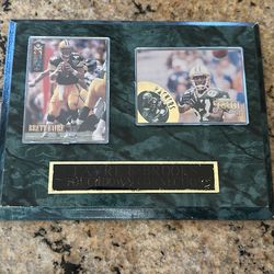 Green Bay Packers players Brett Favre and Robert Brooks. It is a limited edition piece with a green marble-style background.