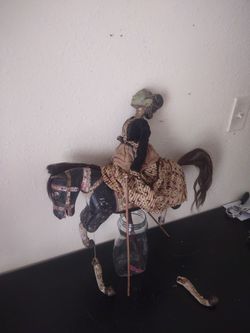 Antique Indonesian puppet riding wooden horse